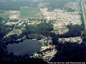 An aerial view of Pennsic War showing many white tents blanketing the landscape.